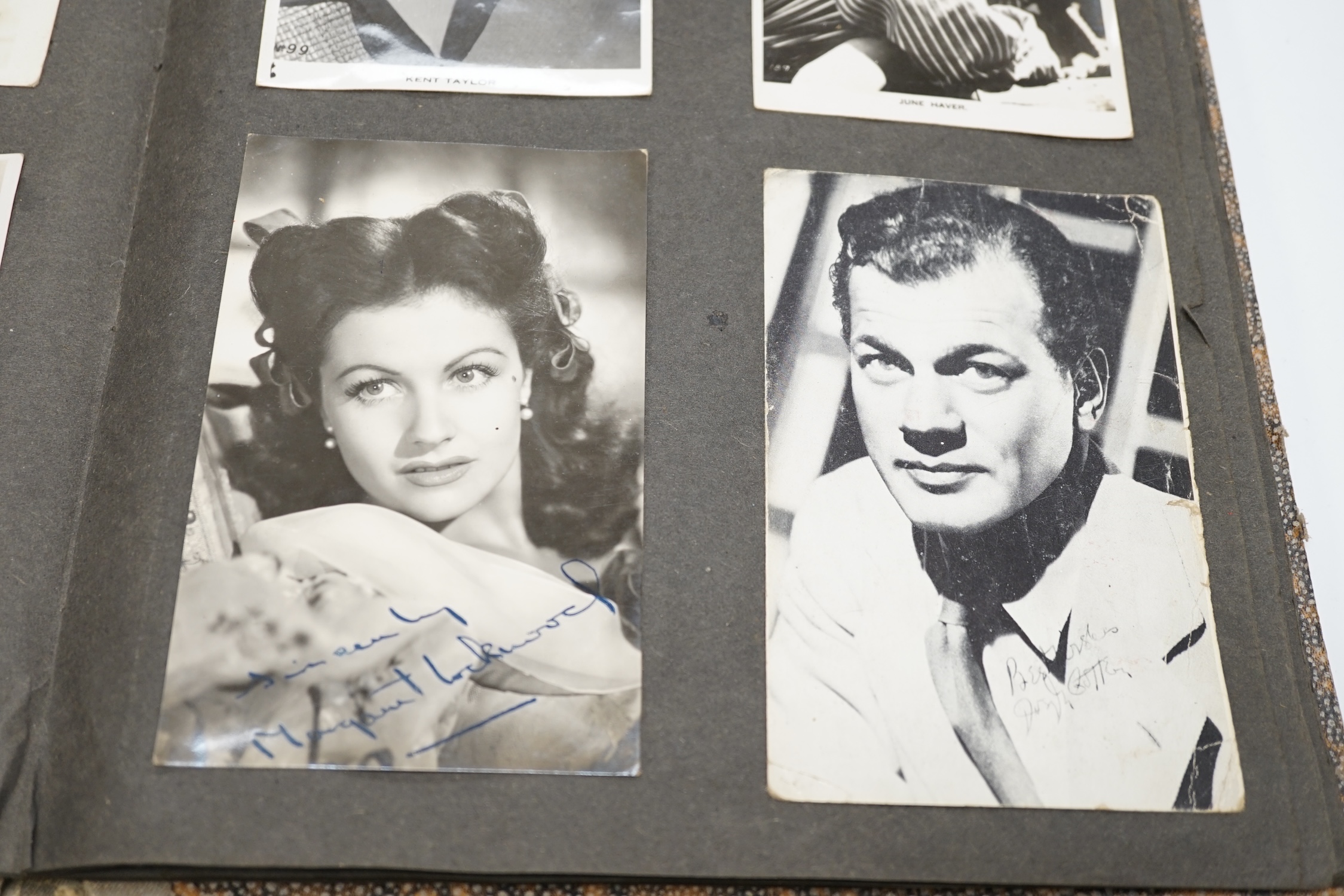 A vintage black and white photograph album with some autographs including Lucille Ball and Margaret O’Brien